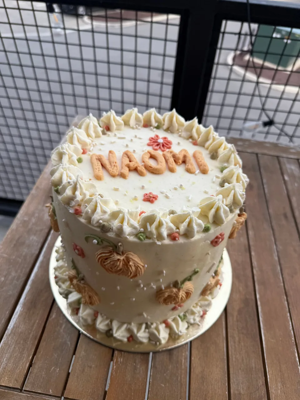 Fall buttercream cake piped with orange pumpkins
